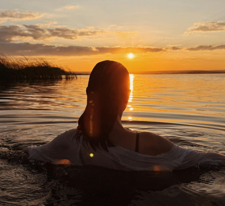 Friday sunset dip in Stirlingshire Swimmer enjoying a peaceful sunset dip during an evening wild swimming session in Stirlingshire