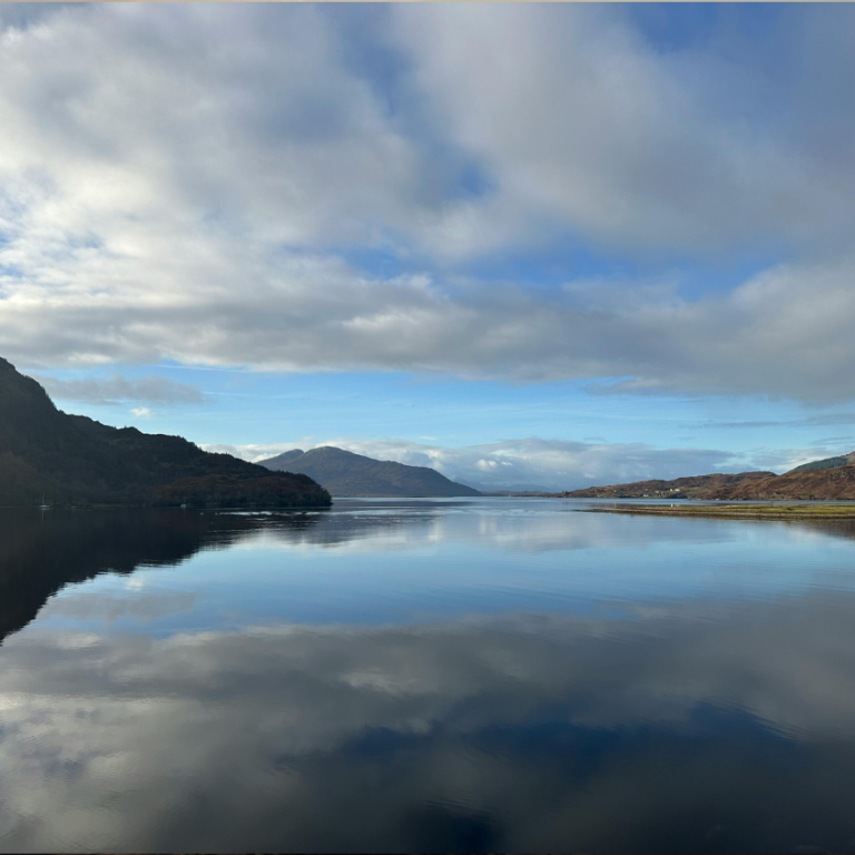 Shore to Crannog open water swimming course Calm Scottish loch surrounded by hills during a Shore to Crannog open water swimming course in Stirlingshire